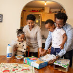 Family with toys on table